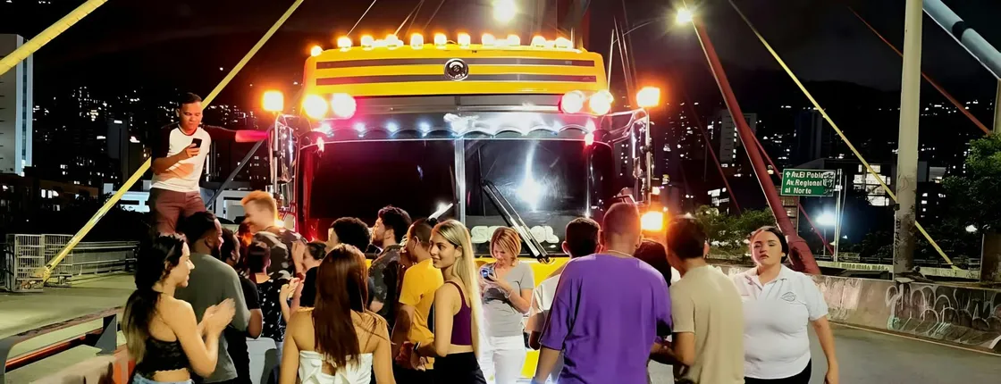 Medellín night tour on an open-air party bus with bar stop