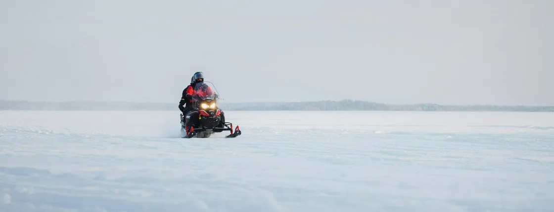Snowmobile safari through Lappish forest